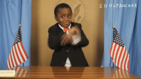 little boy dances the Carlton while at the head of a boardroom table