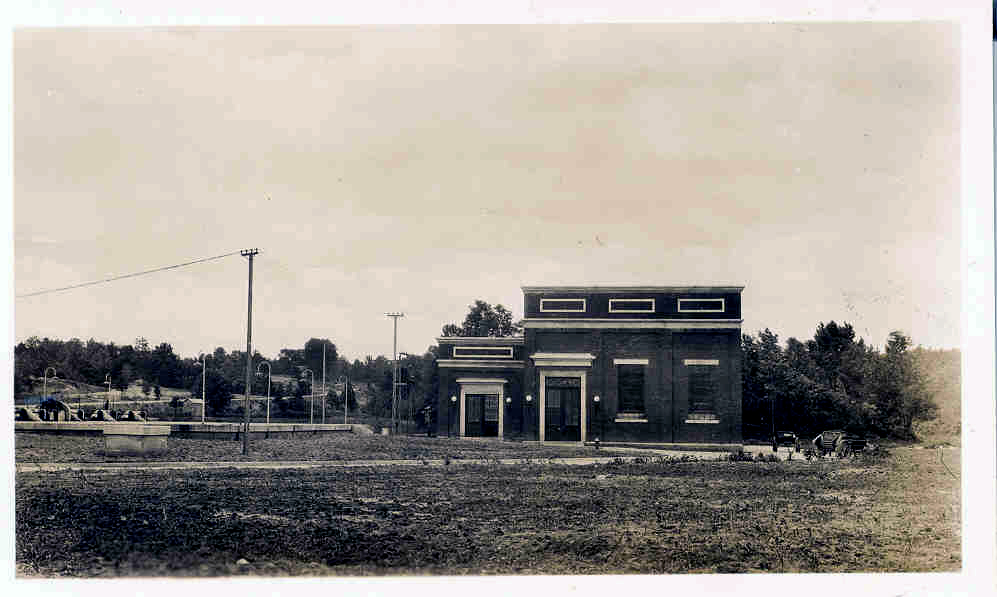 black and white photo of small, brick water treatment facility building from an earlier era
