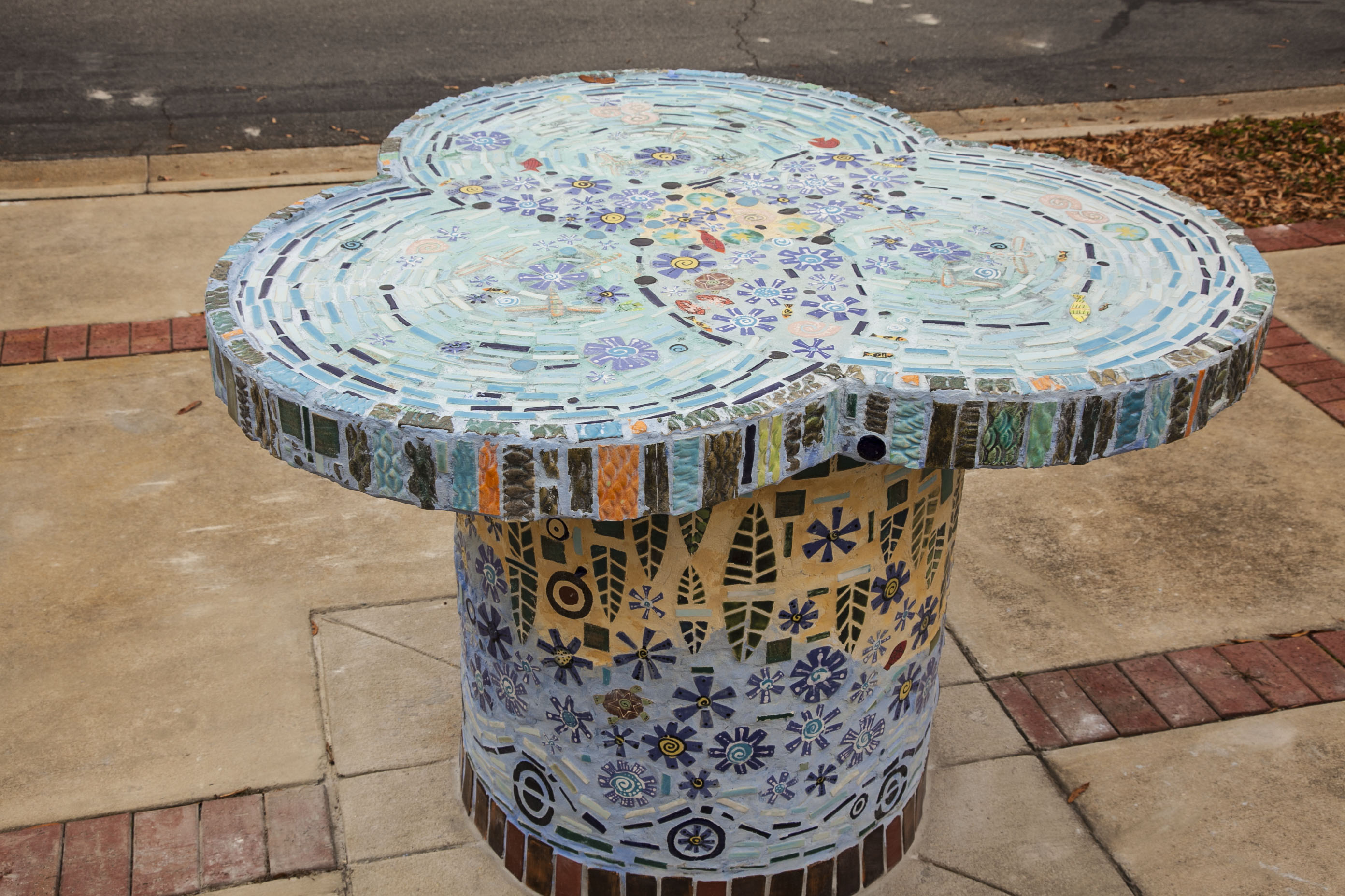 mosaic designed table is colorful public art on a city street