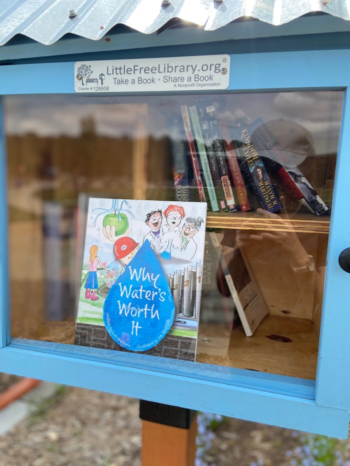 blue curbside lending library box featuring children's book Why Water's Worth It