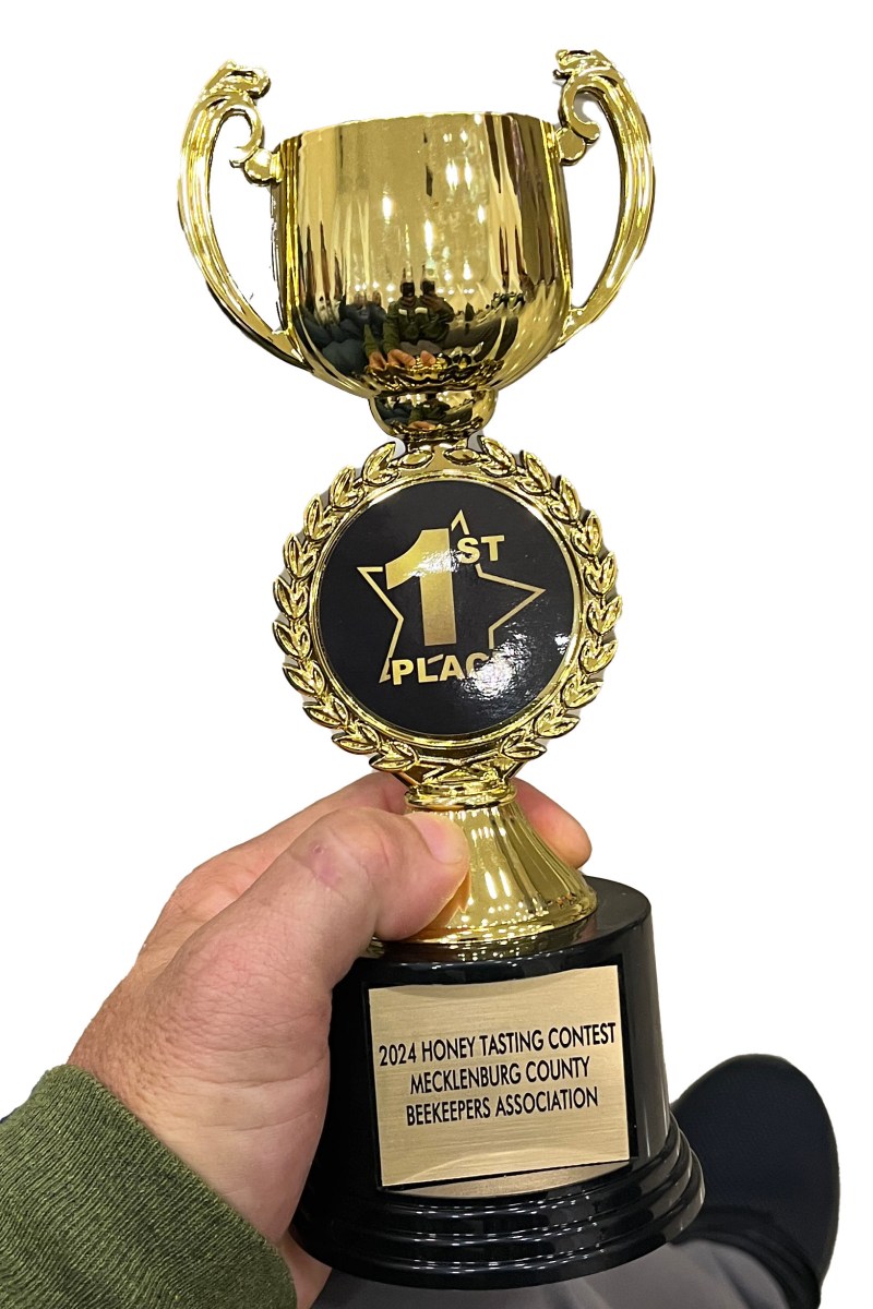Golden trophy for 1st place awarded for the 2024 Honey Tasting Contest, Mecklenburg County Beekeeper's Association